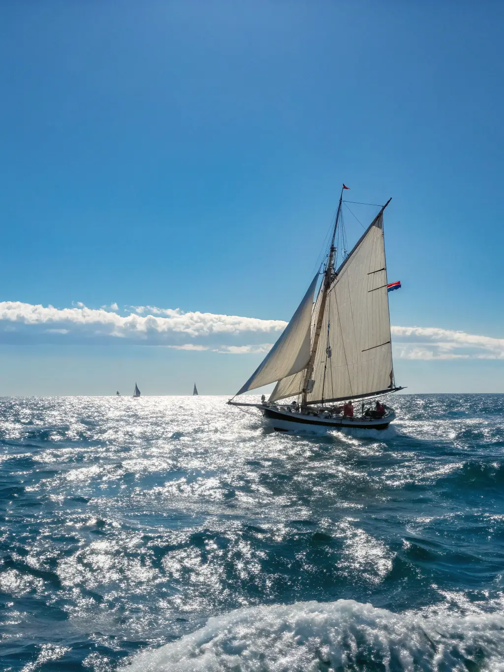 A dynamic image of a sailboat racing during a club-organized nautical event, capturing the excitement and challenge of competitive sailing.